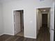 Bright hallway featuring wood-look flooring and white trim doors leading to various rooms of the home at 6021 Westgate Dr # 813, Orlando, FL 32835