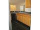 Practical kitchen features a stainless steel dishwasher, ample countertop space, and wood cabinets at 6021 Westgate Dr # 813, Orlando, FL 32835