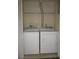 Convenient laundry closet featuring a washer and dryer and shelving for storage at 6021 Westgate Dr # 813, Orlando, FL 32835