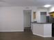 Open-concept living area featuring new flooring and neutral paint, flowing into the kitchen at 6021 Westgate Dr # 813, Orlando, FL 32835