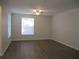 Bright and airy living room with new flooring, a ceiling fan, and a large window at 6021 Westgate Dr # 813, Orlando, FL 32835