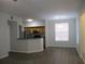 Open layout showcases an inviting living space and breakfast bar leading into the adjacent kitchen at 6021 Westgate Dr # 813, Orlando, FL 32835