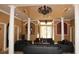 Formal lobby featuring high ceilings, large black leather sofas, and decorative pillars at 6021 Westgate Dr # 813, Orlando, FL 32835