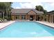 Large community pool with lounge chairs and umbrellas surrounding the pool deck near the clubhouse at 6021 Westgate Dr # 813, Orlando, FL 32835
