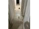 Straight hallway featuring tile floors, neutral walls, and several doors leading to rooms at 6113 Hialeah St, Orlando, FL 32808