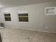 Inviting living room featuring tile floors, bright natural light, and neutral walls at 6113 Hialeah St, Orlando, FL 32808