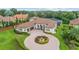 Aerial view showcasing the home's circular driveway, fountain, lush landscaping, and private screened pool at 6233 Rydal Ct, Windermere, FL 34786