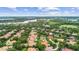 Expansive aerial view showcases a neighborhood with tree-lined streets and a lake nearby at 6233 Rydal Ct, Windermere, FL 34786