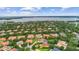Picturesque aerial shot of a neighborhood featuring beautiful homes nestled among mature trees and landscaping at 6233 Rydal Ct, Windermere, FL 34786