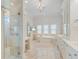 Luxurious bathroom features a standalone tub, walk-in shower, and elegant vanity, offering a spa-like retreat at 6233 Rydal Ct, Windermere, FL 34786