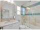 A bright bathroom with a decorative mirror, a shower/tub combo, and ample light at 6233 Rydal Ct, Windermere, FL 34786