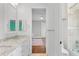 Bathroom featuring double sinks, granite countertops, and shower with glass door at 6233 Rydal Ct, Windermere, FL 34786