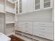 Well-organized walk-in closet with custom shelving and drawers, providing ample storage space for clothing and accessories at 6233 Rydal Ct, Windermere, FL 34786