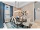 Bright dining room featuring a modern light fixture and blue accent curtains at 6233 Rydal Ct, Windermere, FL 34786