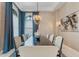 Formal dining room with stylish chandelier, neutral walls, and large windows at 6233 Rydal Ct, Windermere, FL 34786
