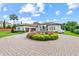 Stunning Mediterranean-style home with a circular driveway, mature landscaping, and a water fountain feature at 6233 Rydal Ct, Windermere, FL 34786
