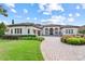 Charming home with a manicured lawn, circular driveway, fountain, and beautiful landscaping at 6233 Rydal Ct, Windermere, FL 34786