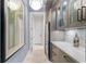 Elegant hallway with a chandelier, marble countertop, wine cooler, and decorative artwork at 6233 Rydal Ct, Windermere, FL 34786