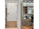 Hallway featuring decorative chandelier that leads into a home office with custom cabinetry and desk at 6233 Rydal Ct, Windermere, FL 34786