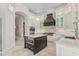 Gourmet kitchen featuring custom white cabinetry, a large center island, and professional-grade appliances at 6233 Rydal Ct, Windermere, FL 34786