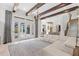 Open-concept living room boasts beamed ceilings, modern lighting, and seamless indoor-outdoor access at 6233 Rydal Ct, Windermere, FL 34786