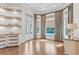 Inviting living room boasts hardwood floors, stylish built-ins, and an abundance of natural light from large windows at 6233 Rydal Ct, Windermere, FL 34786