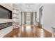 Bright living room with hardwood floors, a fireplace, large windows, and custom built-ins at 6233 Rydal Ct, Windermere, FL 34786