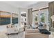 Elegant living room featuring neutral tones, comfortable seating, and seamless transition to the outdoor area at 6233 Rydal Ct, Windermere, FL 34786