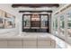 Comfortable living room offers a large sectional sofa, custom built-ins, and access to an outdoor patio and pool area at 6233 Rydal Ct, Windermere, FL 34786