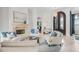 Elegant living room with a stone fireplace, soaring ceilings, and ample natural light at 6233 Rydal Ct, Windermere, FL 34786