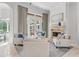 Cozy living room with a stone fireplace and french doors at 6233 Rydal Ct, Windermere, FL 34786