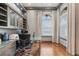 This home office features hardwood floors, a large glass desk, and custom shelving at 6233 Rydal Ct, Windermere, FL 34786