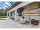 Outdoor bar and lounge featuring a granite countertop, televisions, ceiling fans, and comfortable seating at 6233 Rydal Ct, Windermere, FL 34786