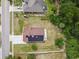 An aerial view of a home showcasing the roof and solar panels, a driveway, and the surrounding landscape at 7243 Minippi Dr, Orlando, FL 32818