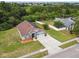 A beautiful single-story home with an attached two-car garage, solar panels, and a well-manicured front yard at 7243 Minippi Dr, Orlando, FL 32818