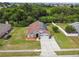 A single-story home boasts solar panels, a brick facade, and a well-maintained lawn with a driveway and landscaping at 7243 Minippi Dr, Orlando, FL 32818