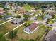 An aerial view of a home with solar panels, a backyard patio, and a well-maintained lawn in a residential area at 7243 Minippi Dr, Orlando, FL 32818