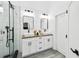 Bright bathroom featuring dual sinks, wood countertops, white cabinets, and a walk-in shower at 7243 Minippi Dr, Orlando, FL 32818