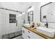 Beautiful bathroom showcasing a glass-enclosed shower with decorative tile accent and double sink vanity at 7243 Minippi Dr, Orlando, FL 32818