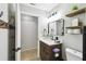 Bathroom with a wooden vanity, framed mirror, decorative shelves, and light gray paint at 7243 Minippi Dr, Orlando, FL 32818