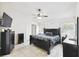 Spacious bedroom with tiled floors, ceiling fan, black furniture and wall decorations at 7243 Minippi Dr, Orlando, FL 32818