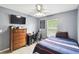 Bedroom with gray walls, ceiling fan, a dresser, a twin bed, desk and tiled floors at 7243 Minippi Dr, Orlando, FL 32818