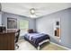 Cozy bedroom with gray walls, a ceiling fan, a twin bed, and tiled floors at 7243 Minippi Dr, Orlando, FL 32818