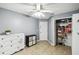 Spare bedroom with ceiling fan, ceramic tile floors, closet and small storage chest at 7243 Minippi Dr, Orlando, FL 32818