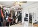 Walk-in closet with clothing racks and shelves; door leads to the bedroom at 7243 Minippi Dr, Orlando, FL 32818