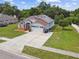 Well-maintained home with solar panels, landscaped yard, and long driveway at 7243 Minippi Dr, Orlando, FL 32818