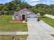 Charming home with a well-manicured lawn, mature landscaping, and a spacious driveway at 7243 Minippi Dr, Orlando, FL 32818