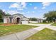 Charming single-Gathering home featuring a well-maintained lawn and attached two-car garage at 7243 Minippi Dr, Orlando, FL 32818
