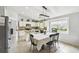 Bright kitchen and dining area featuring tile flooring, stainless steel appliances, and modern light fixture at 7243 Minippi Dr, Orlando, FL 32818