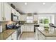 Bright kitchen with granite countertops, tile backsplash, stainless steel appliances, and island at 7243 Minippi Dr, Orlando, FL 32818